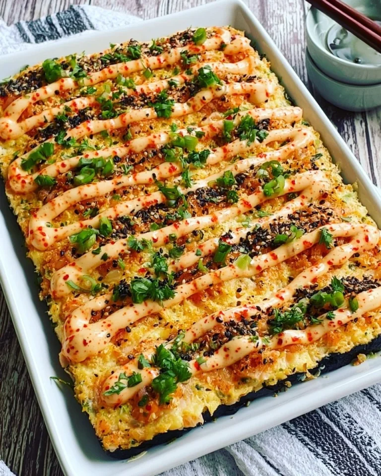 Delicious salmon sushi bake topped with creamy sauce and crispy toppings