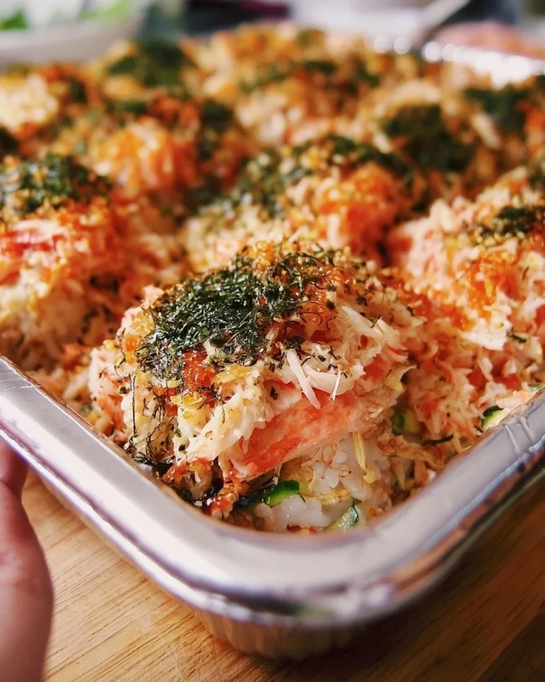 Delicious homemade Sushi Bake served in a casserole dish with toppings.